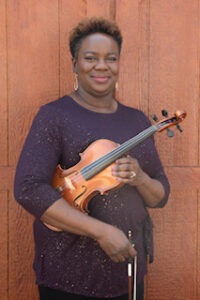 Chenoa Murphy smiling and holding a violin